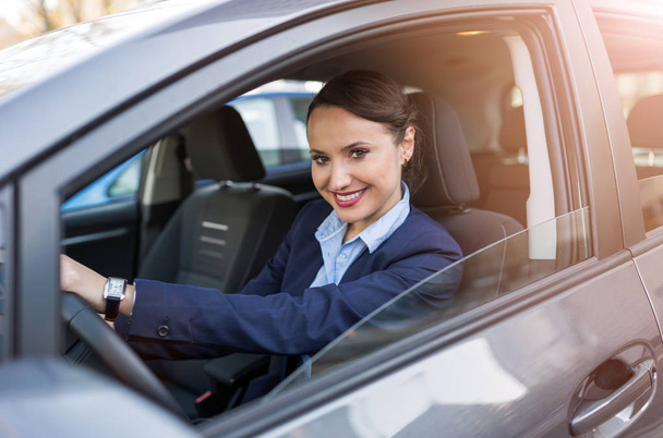 Businesswoman driving a car - Foto, afbeelding