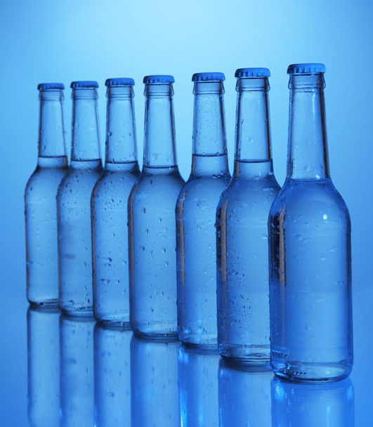 Water bottles on blue background - Foto, immagini