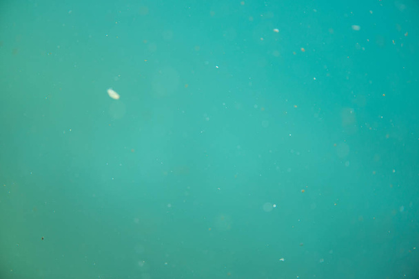 Green underwater pattern with dirt and dust as seen through glass - Fotoğraf, Görsel