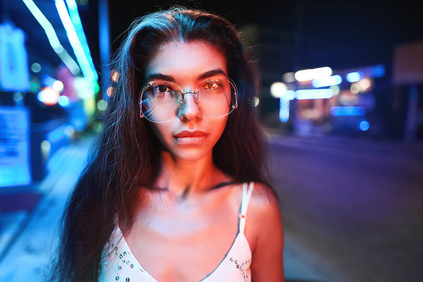 portrait of a beautiful young woman with glasses in futuristic neon light - Foto, Imagem