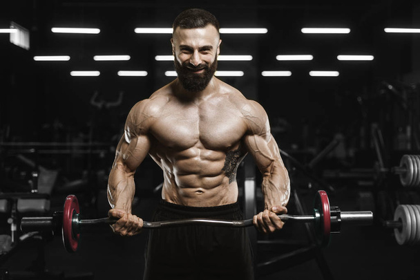 Handsome strong athletic men pumping up muscles workout barbell  - Fotó, kép