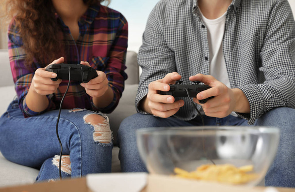 Young couple playing video games at home, closeup - Photo, image