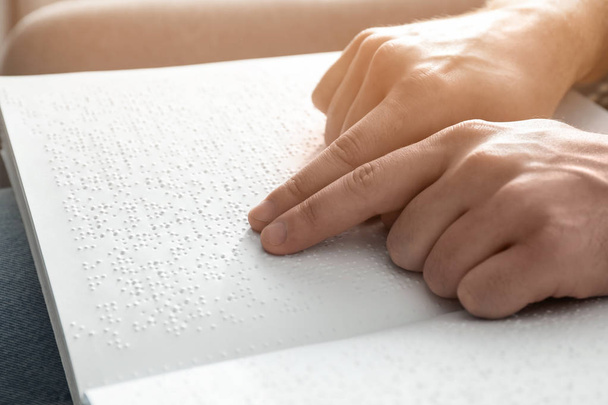 Blind man reading book written in Braille, closeup - Fotografie, Obrázek