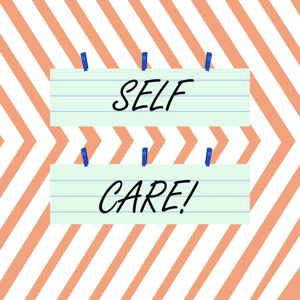 Writing note showing Self Care. Business photo showcasing practice of taking action preserve or improve ones own health Strip Size Lined Paper Sheet Hanging Using Blue Clothespin. - Photo, Image