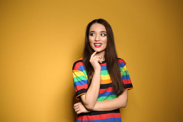 Portrait of beautiful young woman on colorful background - Zdjęcie, obraz