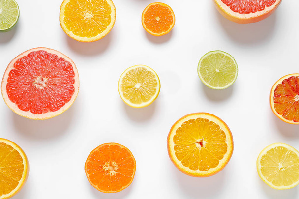 Flat lay composition with different citrus fruits on white background - Foto, immagini