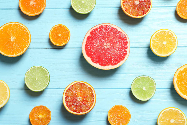 Flat lay composition with different citrus fruits on wooden background - Photo, Image
