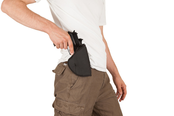 Close-up of a man with holster and a gun - Foto, afbeelding