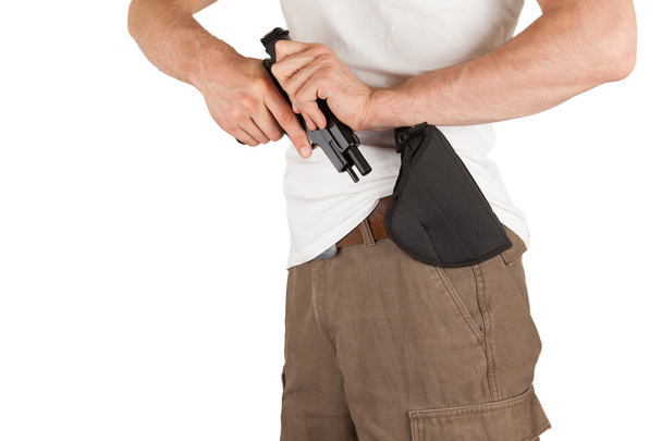 bir adam bir silah ve tabanca kılıfı ile yakın çekim - Fotoğraf, Görsel