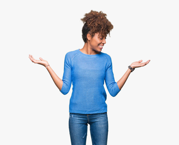 Beautiful young african american woman over isolated background Smiling showing both hands open palms, presenting and advertising comparison and balance - Photo, Image