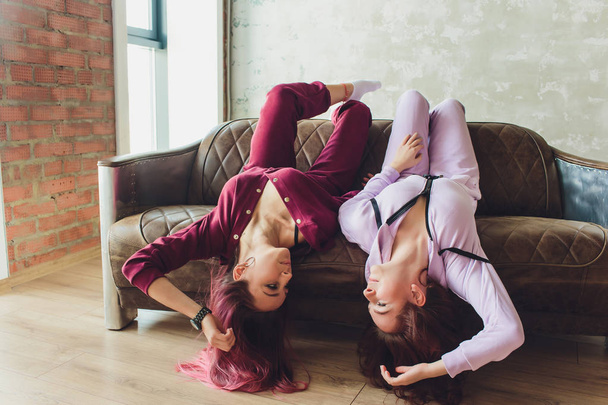 LGBT Cute young girls smiling and flirting on sofa at home. - Fotoğraf, Görsel