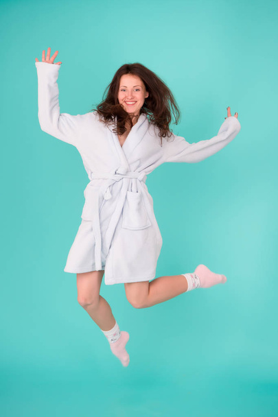 Beauty salon for your relax. Pretty woman happy jumping in dressing bathrobe. Sensual woman after beauty treatment and wellness therapy. Beauty therapy for the entire body. Beauty in mid air - Photo, image