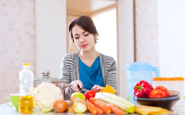 young woman cooking veggie food - Foto, imagen
