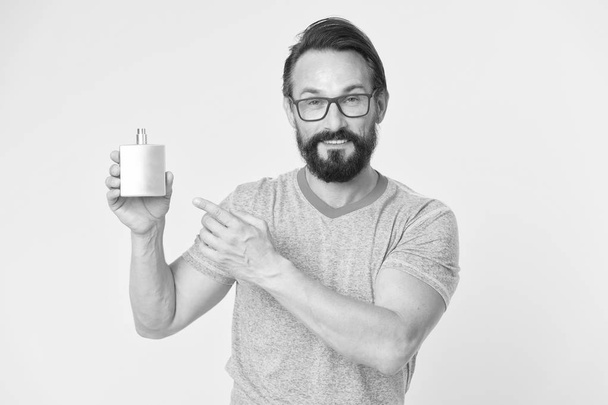 Amazing benefits of using perfumes. Man bearded handsome hold bottle perfume. How choose perfume for men according to occasion. Make sure smell fresh throughout day. Wearing perfume is enhancing mood - Φωτογραφία, εικόνα