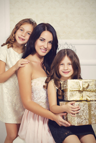 Portrait of luxury family with gold gift boxes - Photo, Image
