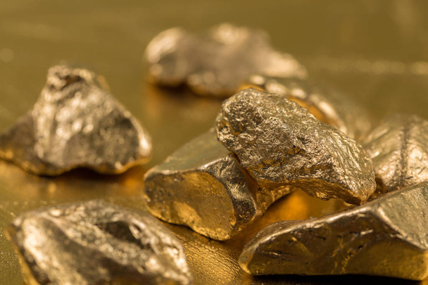 Close up of gold gemstones  - Фото, изображение