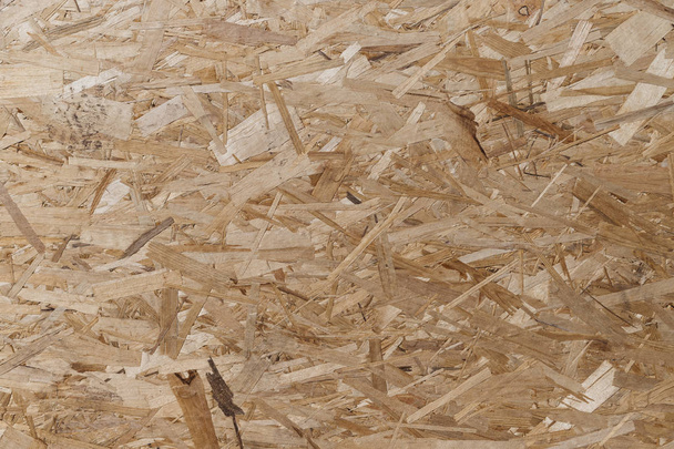 Nyomott és ragasztott faforgács. Rétegelt lemez Absztrakt háttér. rétegelt lemez textúrája nagy faforgácsokból. - Fotó, kép