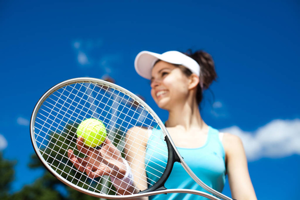 Woman playing tennis, summertime saturated theme - Фото, зображення