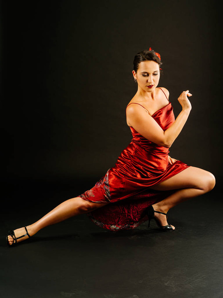 Photo of a young beautiful woman performing tango moves. - Foto, Imagen