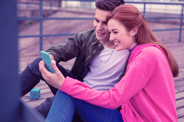 Cheerful good-looking young couple making selfie together - Photo, image