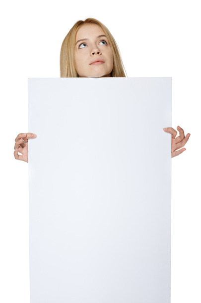 Girl holding peeking out the adge of blank banner - Foto, Bild