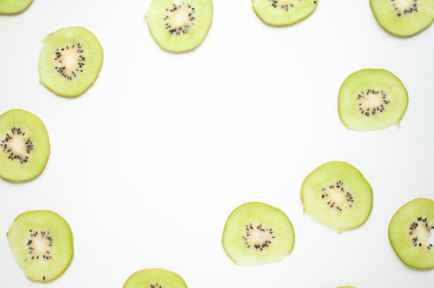 Slices of kiwi. Fruit light background. Green fruit. Vitamins on the table. Kiwi Pattern - Zdjęcie, obraz