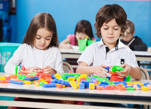 Children Playing With Construction Blocks In Classroom - Photo, Image