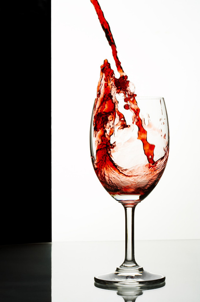 Close up view of wineglass getting filled with red wine - Photo, Image