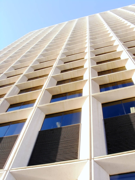 Towering office building on blue sky. - Фото, изображение