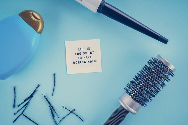 hairdresser's concept: hairbrush, plaice, hairpins on a blue background - Photo, Image