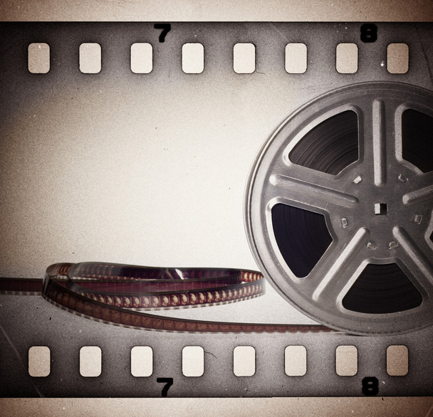 Old motion picture film reel with film strip. Vintage background - Photo, Image