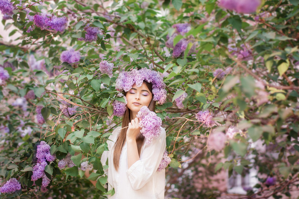 Fashion young woman with lilac flowers - Fotó, kép