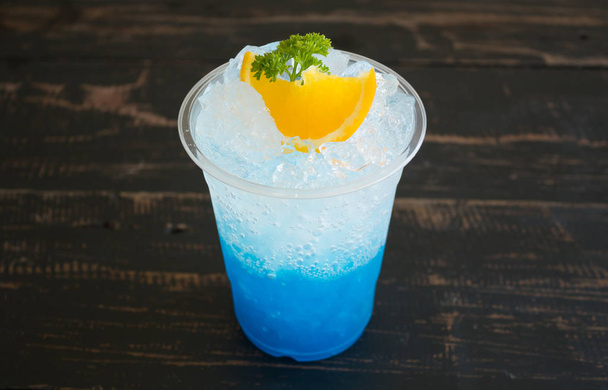 Blue Italian Soda Cold Beverage and Lemon Fruit and Persley Center
 - Photo, image