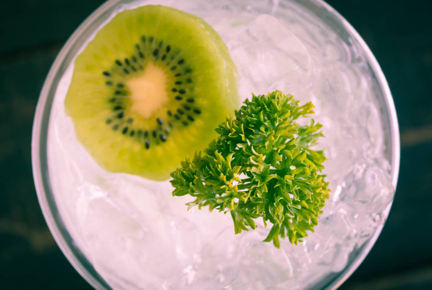 Green Italian Soda Cold Beverage and Kiwi Fruit and Parsley Flatlay Center Close Up Vintage - 写真・画像