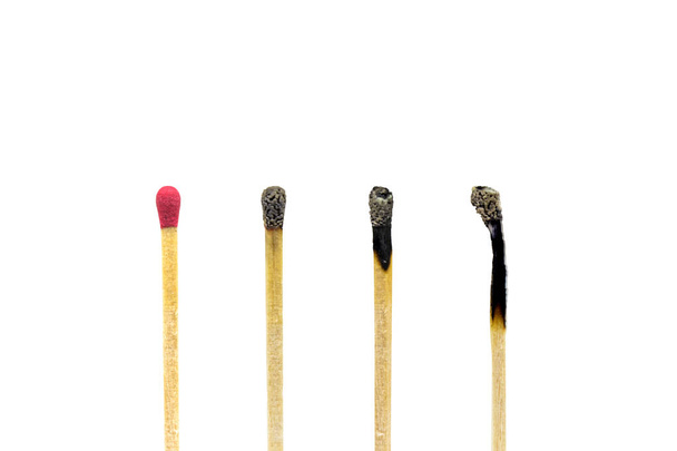 Close up one new wooden match stick standing among burnt matches stick. - Photo, Image