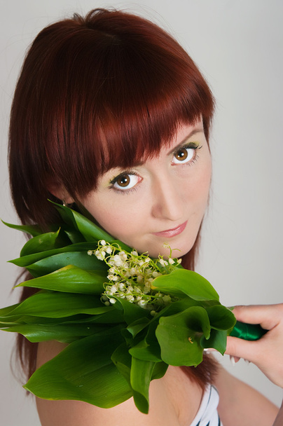 The girl with a bouquet of lilies of the valley - Photo, image