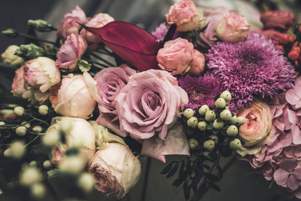 Flower arrangement of different colors. The photo is processed in vintage style, toning and light blur. - Fotó, kép