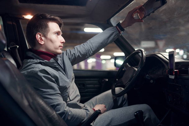 Image from side of man sitting in car - Фото, изображение