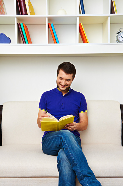 man reading interesting book at home - Photo, Image