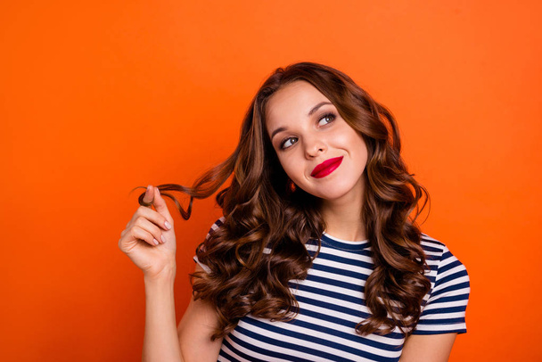 Close up photo beautiful she her lady red lipstick hold play arms curl look up empty space imaginary flight overjoyed wear casual striped white blue t-shirt clothes isolated orange bright background - 写真・画像