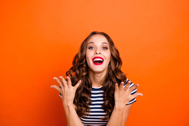 Close up photo beautiful she her lady glossy red lipstick hold arms hands air celebrating fame astonished celebrity wear casual striped white blue t-shirt clothes isolated orange bright background - Foto, immagini