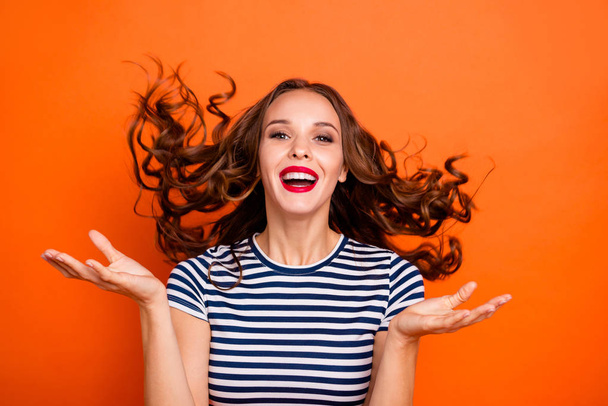 Close up photo amazing beautiful she her lady red lips hand arm palm raised hair curls flight toothy catch rain drops wear casual striped white blue t-shirt clothes isolated orange bright background - Fotoğraf, Görsel