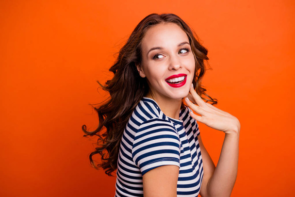 Close up portrait of glad fascinating with perfect tanned skin straight teeth she her lady holding hand near cheek looking aside isolated vivid vibrant background copyspace - Foto, Bild