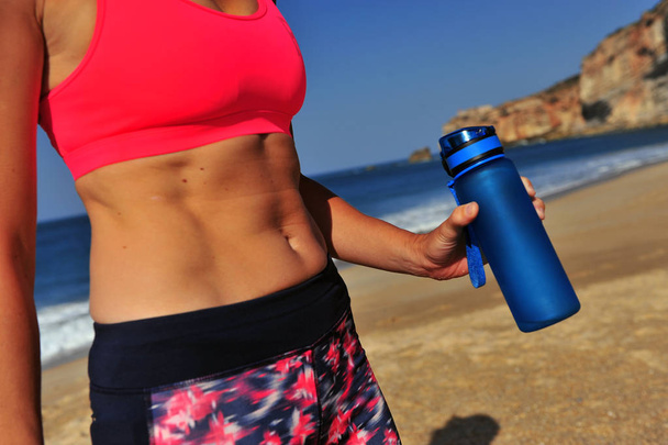 Woman going to drink after exercise - Photo, image