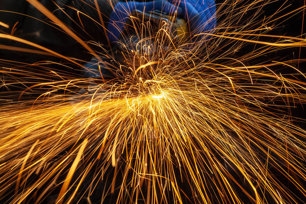 Bright  lighting from spark welding  Iron soldering, Man working on iron soldering, welding sparks.  - Photo, Image