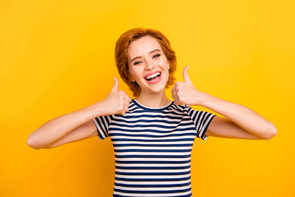 Close up photo beautiful amazing she her lady easy-going thumb up amazed glad advising new product wearing casual striped white blue t-shirt outfit clothes isolated yellow bright vibrant background - Foto, imagen