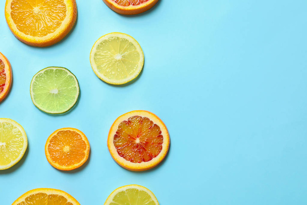 Different citrus fruits on color background, flat lay. Space for text - Fotó, kép