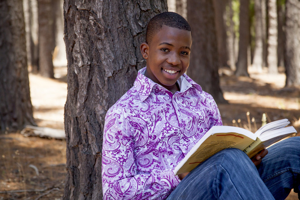 Африканський підліток хлопчик читання книг на відкритому повітрі - Фото, зображення