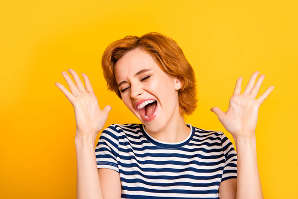 Close up photo beautiful amazing yelling she her lady eyes closed mouth opened hand arm raise best win glad wear casual striped white blue t-shirt outfit clothes isolated yellow bright background - Фото, изображение
