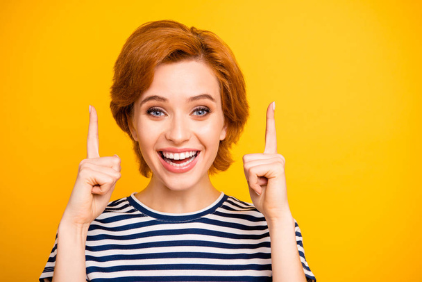 Close up photo beautiful amazing toothy she her lady hands arms indicate up empty space advising buy buyer sell product wear casual striped white t-shirt outfit clothes isolated yellow background - Φωτογραφία, εικόνα